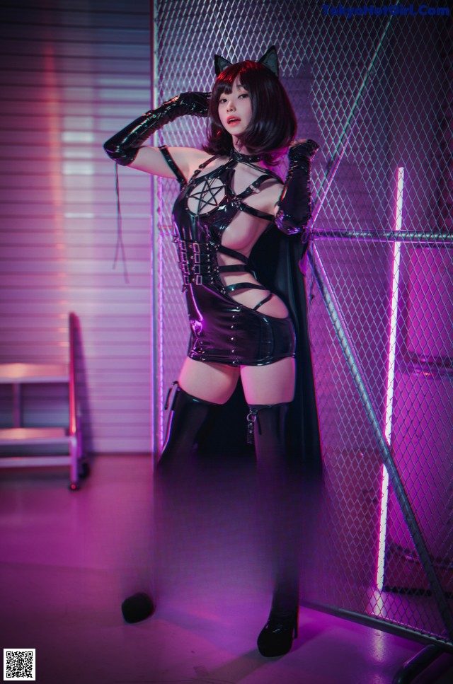A woman dressed as a cat in a halloween costume.