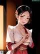A woman in a red and white kimono standing in front of a wall.