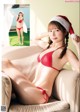 A woman in a red bikini and a santa hat.