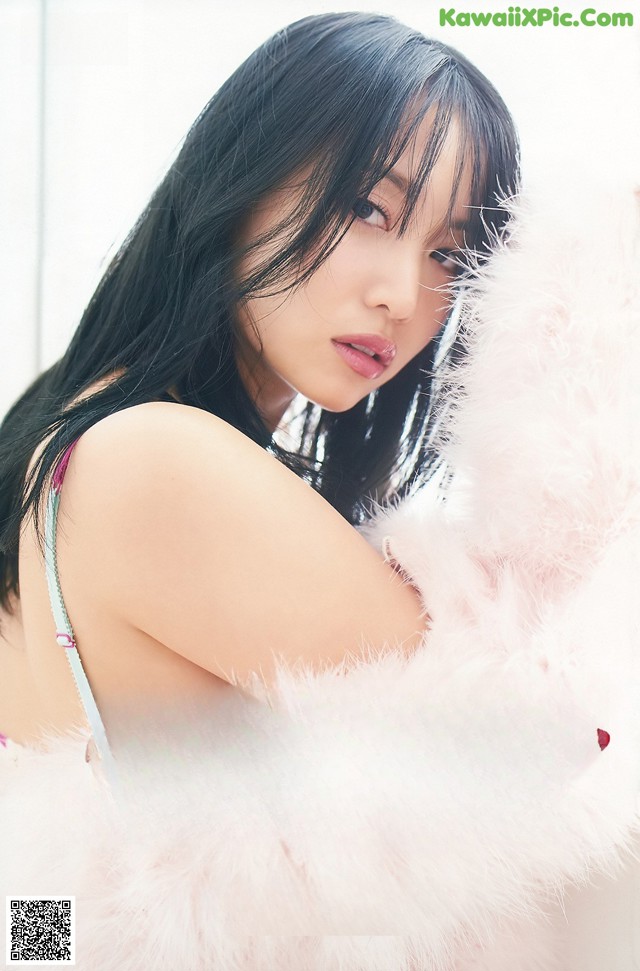 A woman with long black hair is posing for a picture.
